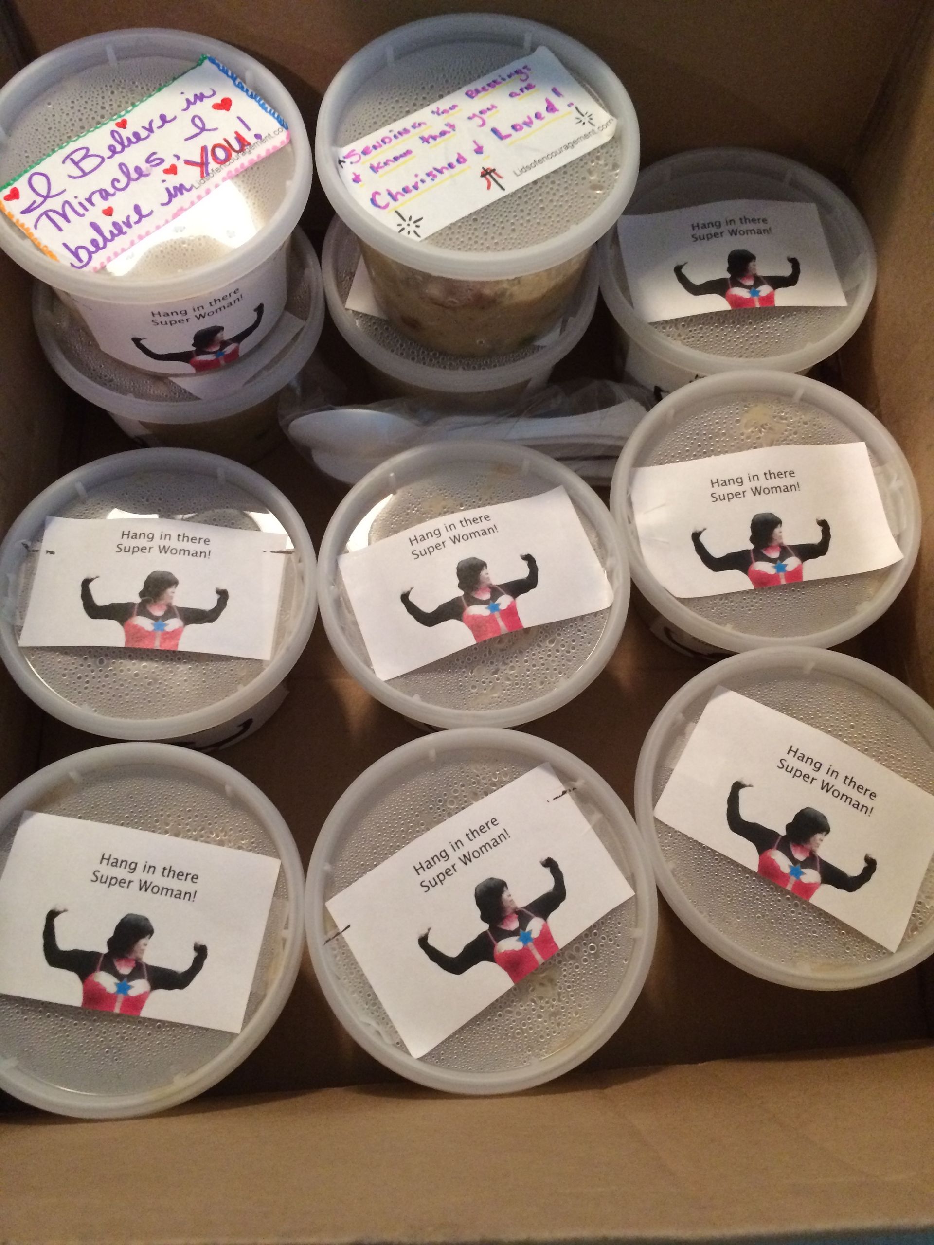 A box filled with small plastic cups with labels on them